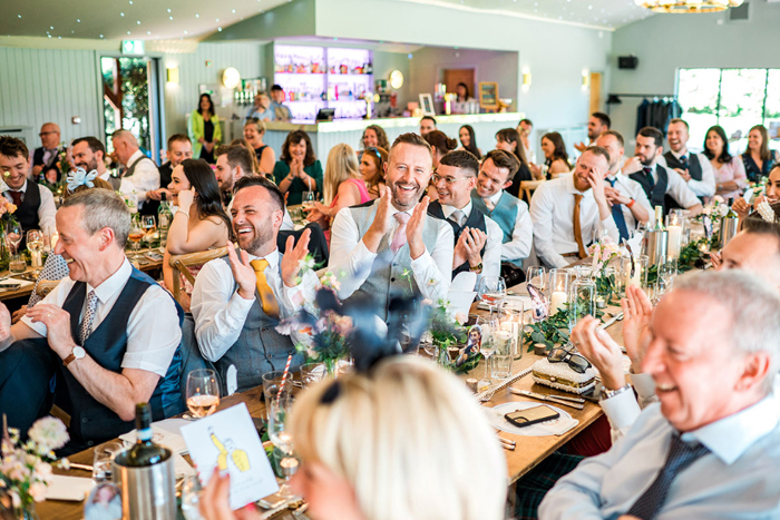 Guests clap during wedding breakfast