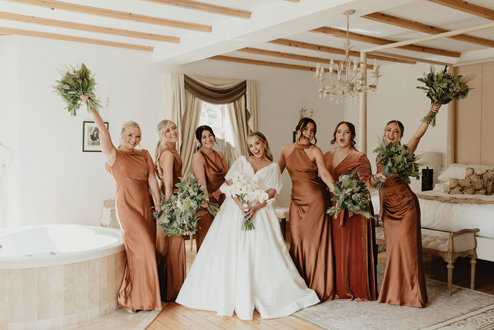 A group of women in dresses in the honeymoon suite at Achnagairn Castle.