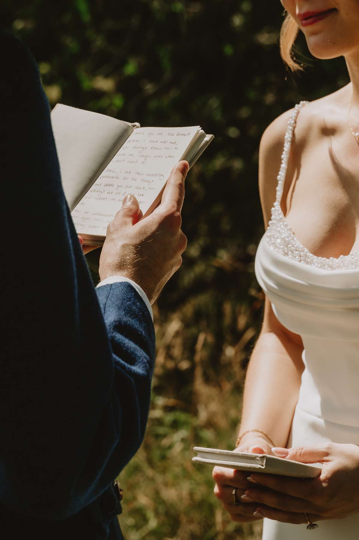 Bride and groom reading personal vows during their outdoor wedding ceremony at Ballogie House