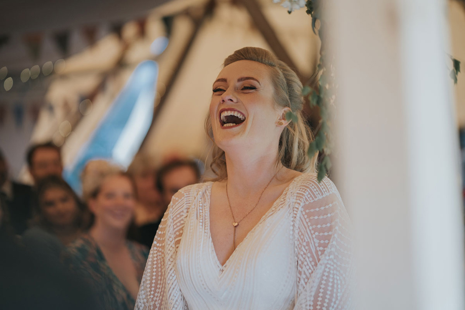 Bride laughs during ceremony