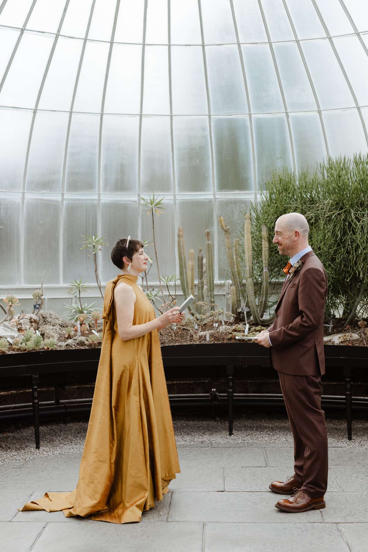 Couple exchanging personal vows during a Kibble Palace wedding ceremony
