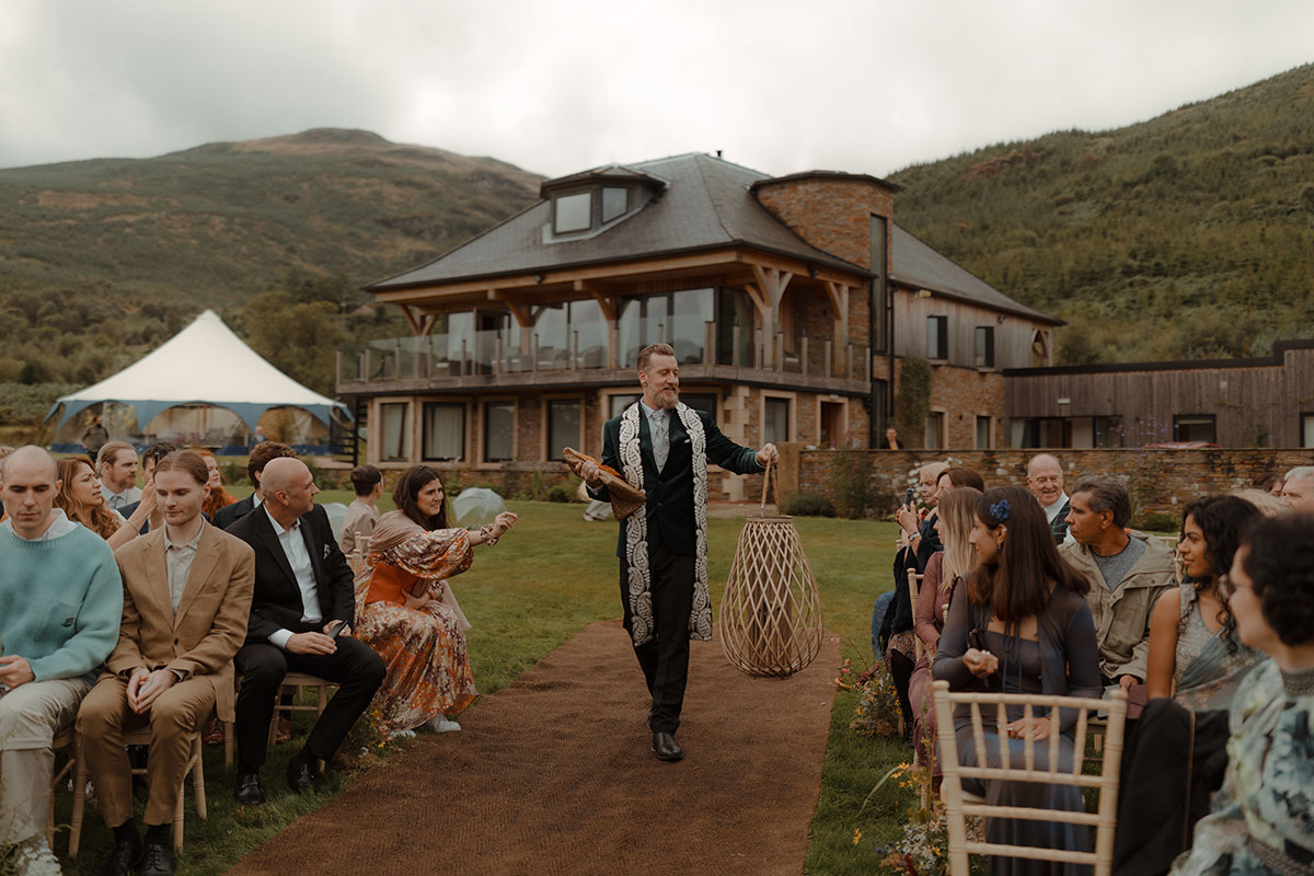 wedding guests and celebrant assembled for outdoor pagan wedding ceremony at Carrick Castle Estate