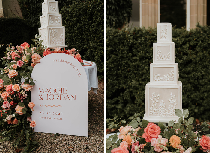 A stunning display of florals, wedding welcome sign and four-tier cube wedding cake