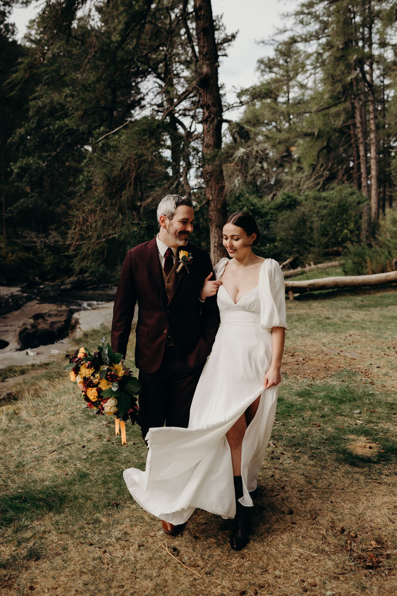 a bride and groom walking through woodland countryside on Mar Lodge Estate
