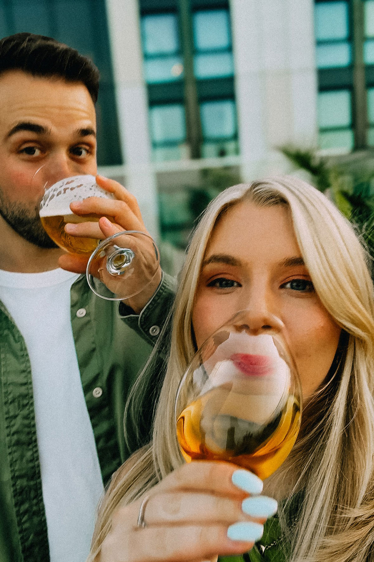 Engaged couple enjoying drinks together during a pre-wedding celebration at a city hotel