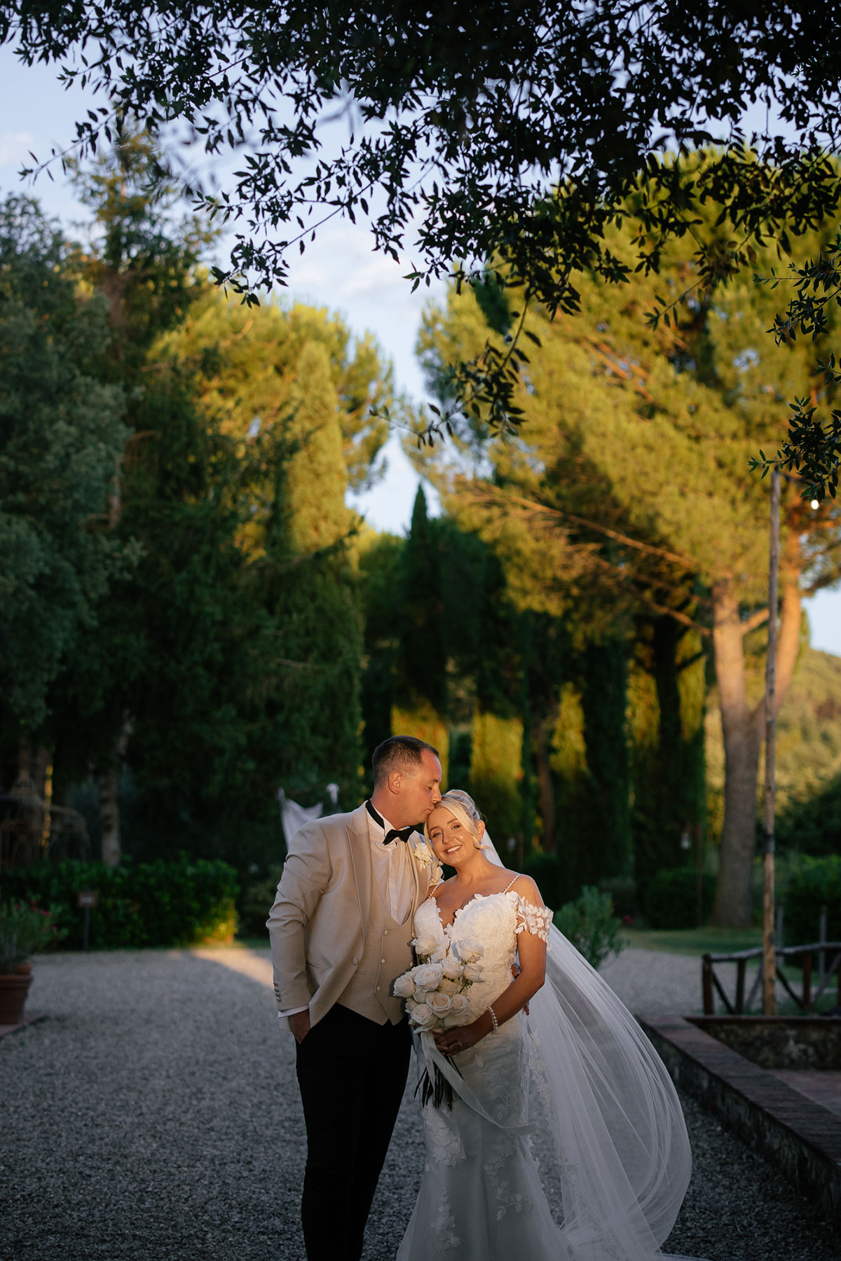 Bride and groom sunset portrait in Tuscan garden at Antico Borgo San Lorenzo wedding venue