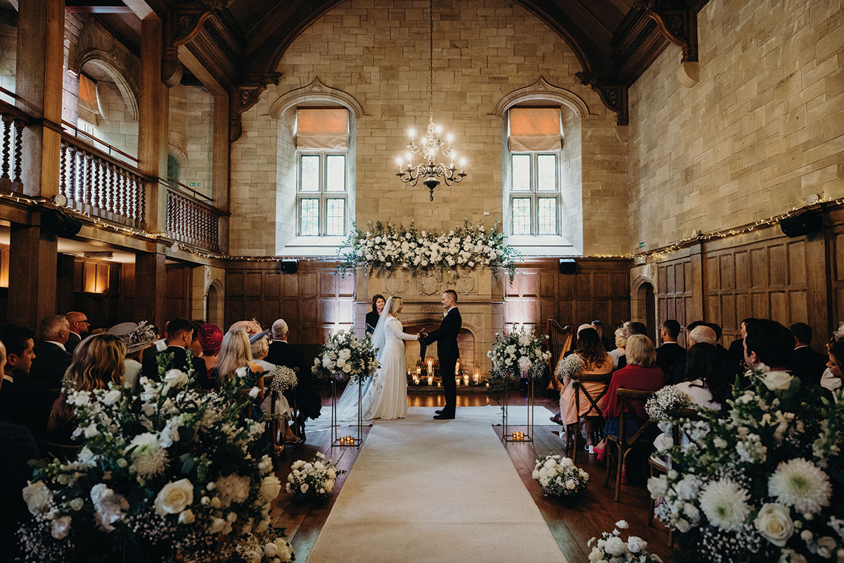 ceremony set up for couple at Achnagairn Castle with large floral displays