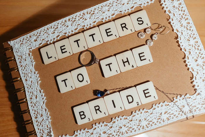 scrapbook with scrabble letters on top reading letters to the bride