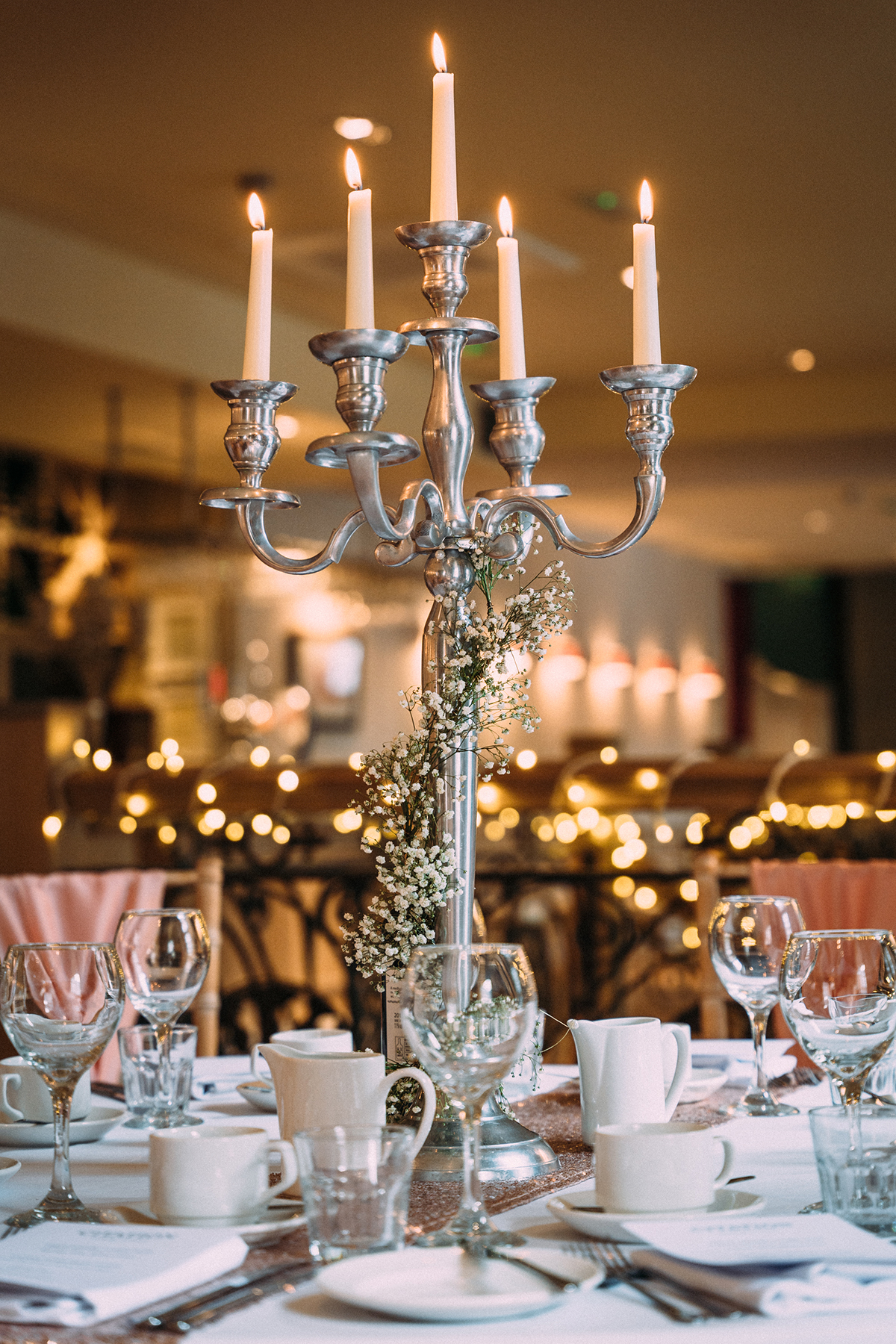 Candlelit wedding reception table styling at Citation Glasgow with silver candelabra and fairy lights