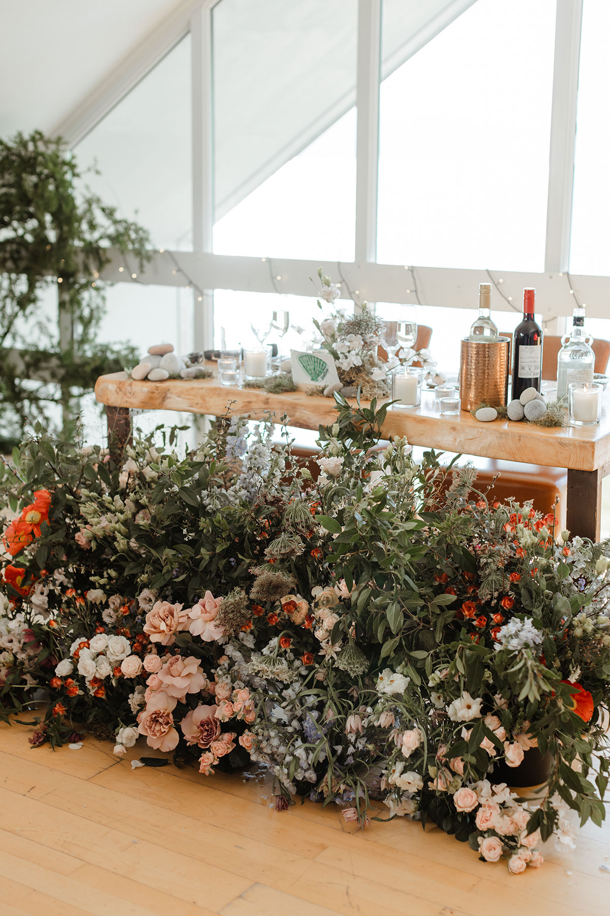 Bride and groom's table with large floral arrangement in front