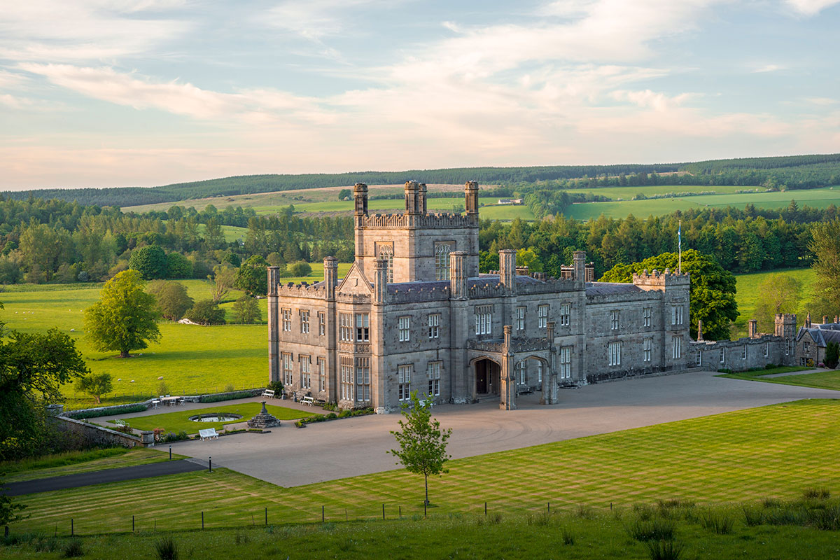 Aerial view of Blairquhan Castle in Ayrshire, surrounded by rolling countryside, landscaped grounds and sweeping lawns