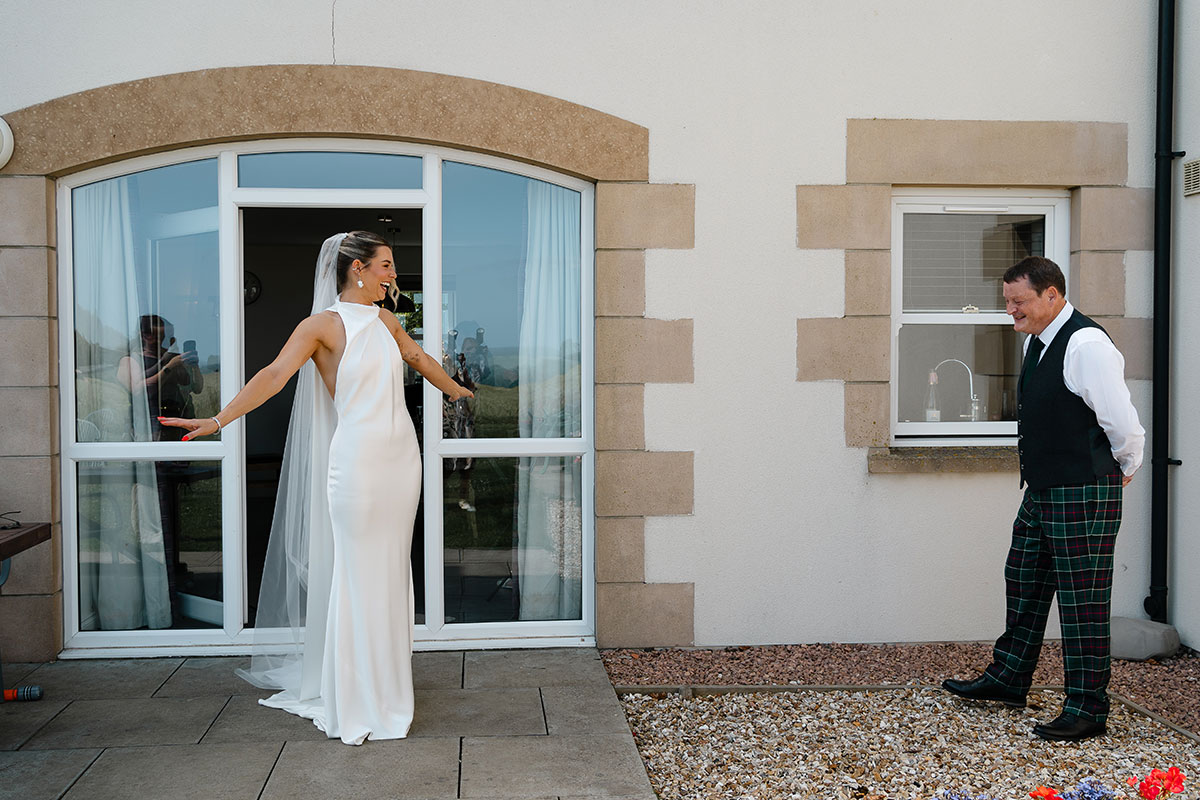 Bride shares an emotional first look with her father outside the accommodation at Kinkell Byre before the wedding ceremony.