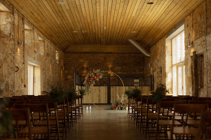 ceremony set up with chairs and floral display at falside mill wedding