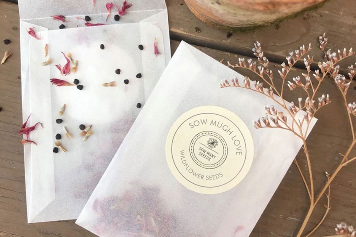 Wildflower seed packet wedding favours with petals and rustic floral styling