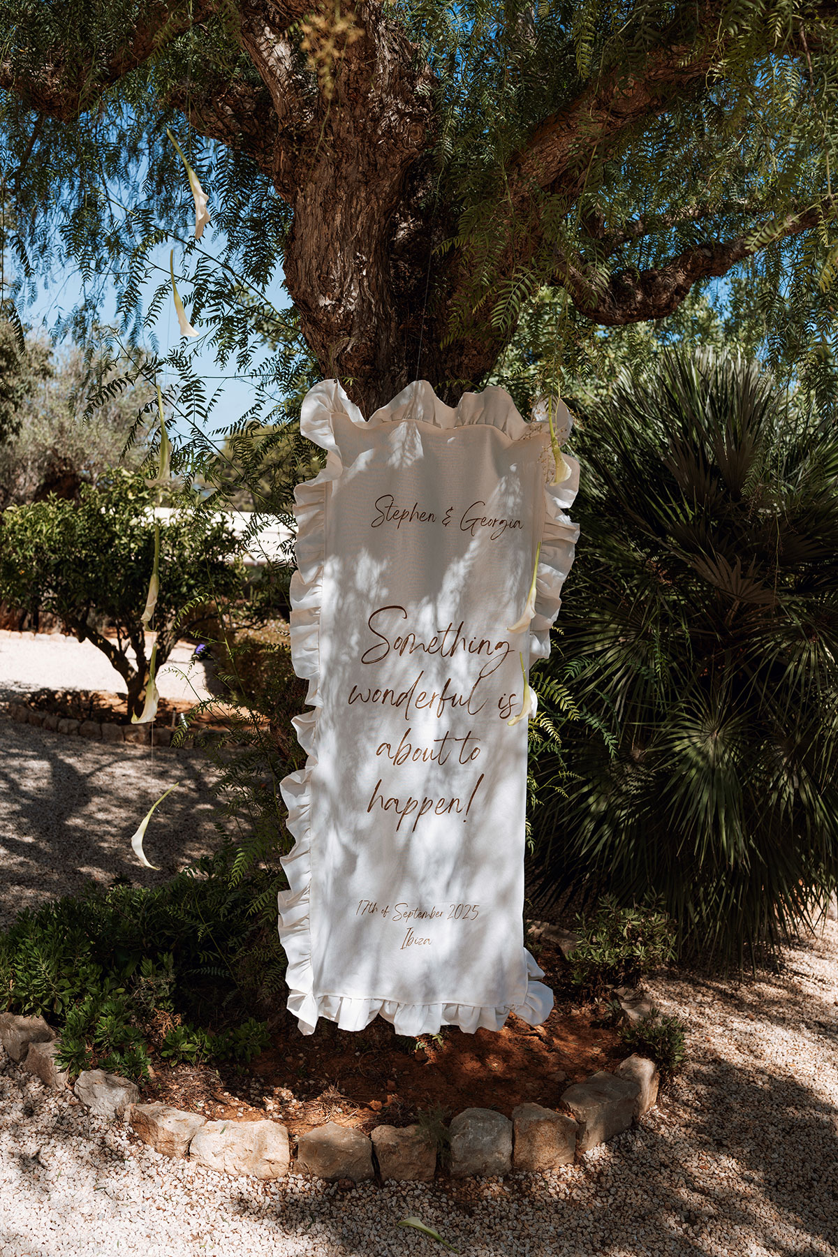 Frilled wedding sign reading “Something wonderful is about to happen” displayed at Can Rafal Ibiza wedding venue