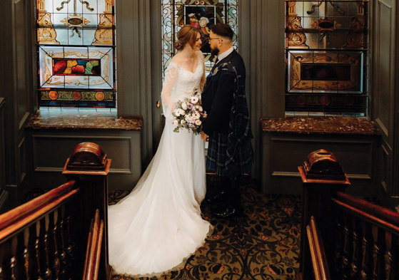 bride and groom on the stairs at One Devonshire Gardens at Glasgow’s Hotel du Vin