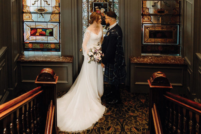 bride and groom on the stairs at One Devonshire Gardens at Glasgow’s Hotel du Vin