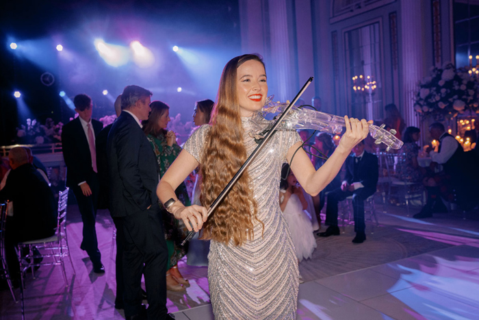 Performer plays violin at reception