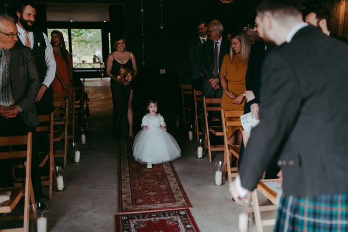 Couple's daughter walks down aisle towards her father the groom