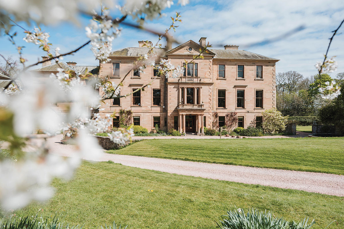 Exterior of Cambo House with gardens in bloom, exclusive-use wedding venue in Fife