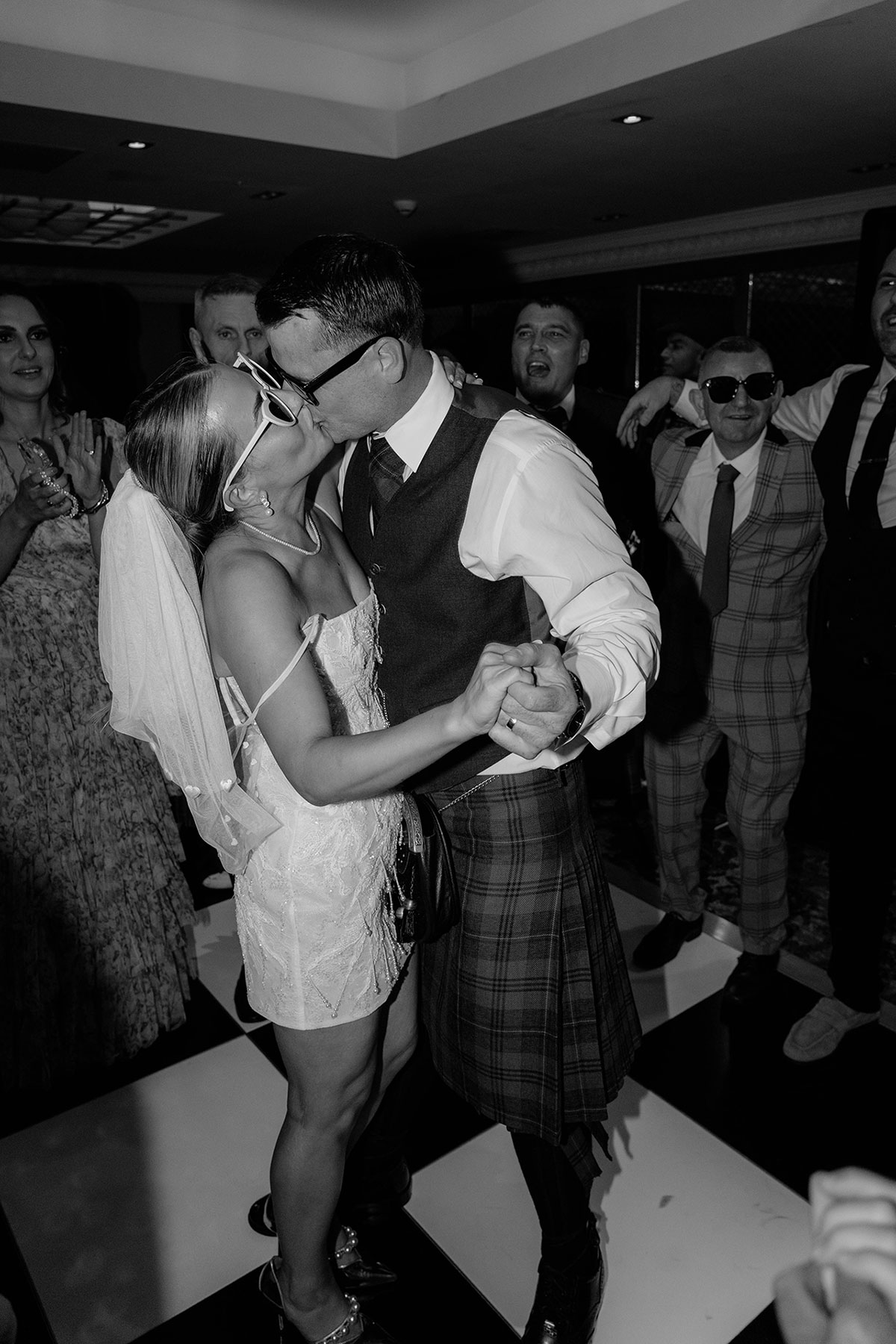 Bride and groom dancing together surrounded by guests at Brisbane House Hotel wedding party