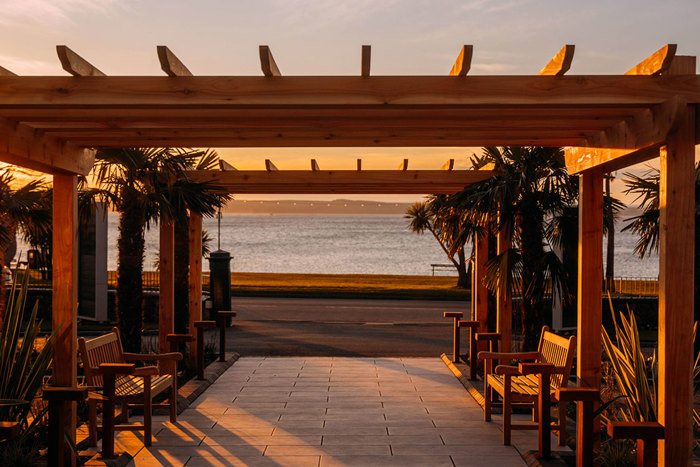 sunset glow on outdoor benches with ocean view straight ahead