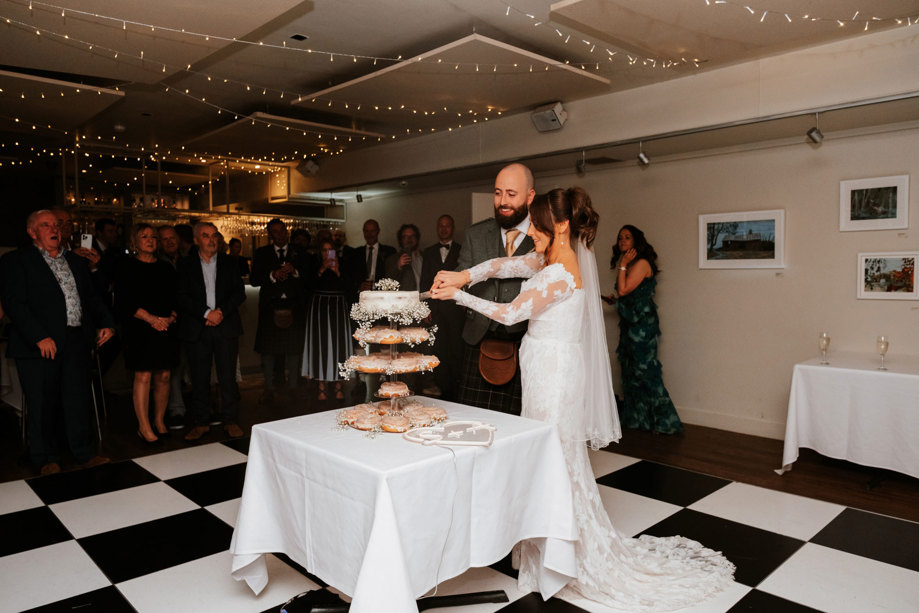 Bride and groom cut their wedding cake 