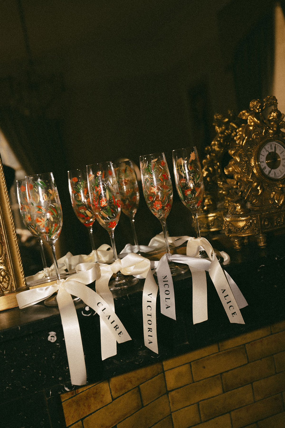 Personalised champagne flutes with ribbon name tags for bridal party at elegant Scottish wedding reception