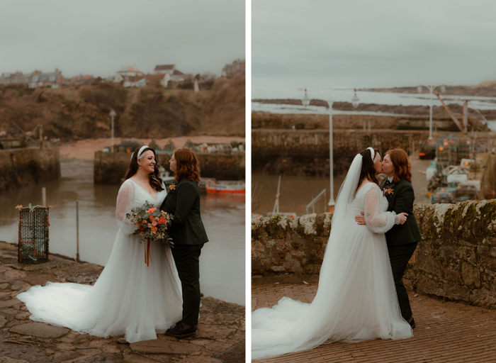 two brides kissing and posing for a photo with Crail Harbour in the background