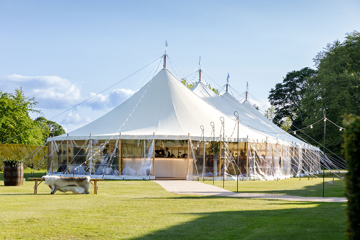 Hill of Tarvit garden marquee wedding setup with white sail tent on manicured lawns and countryside backdrop