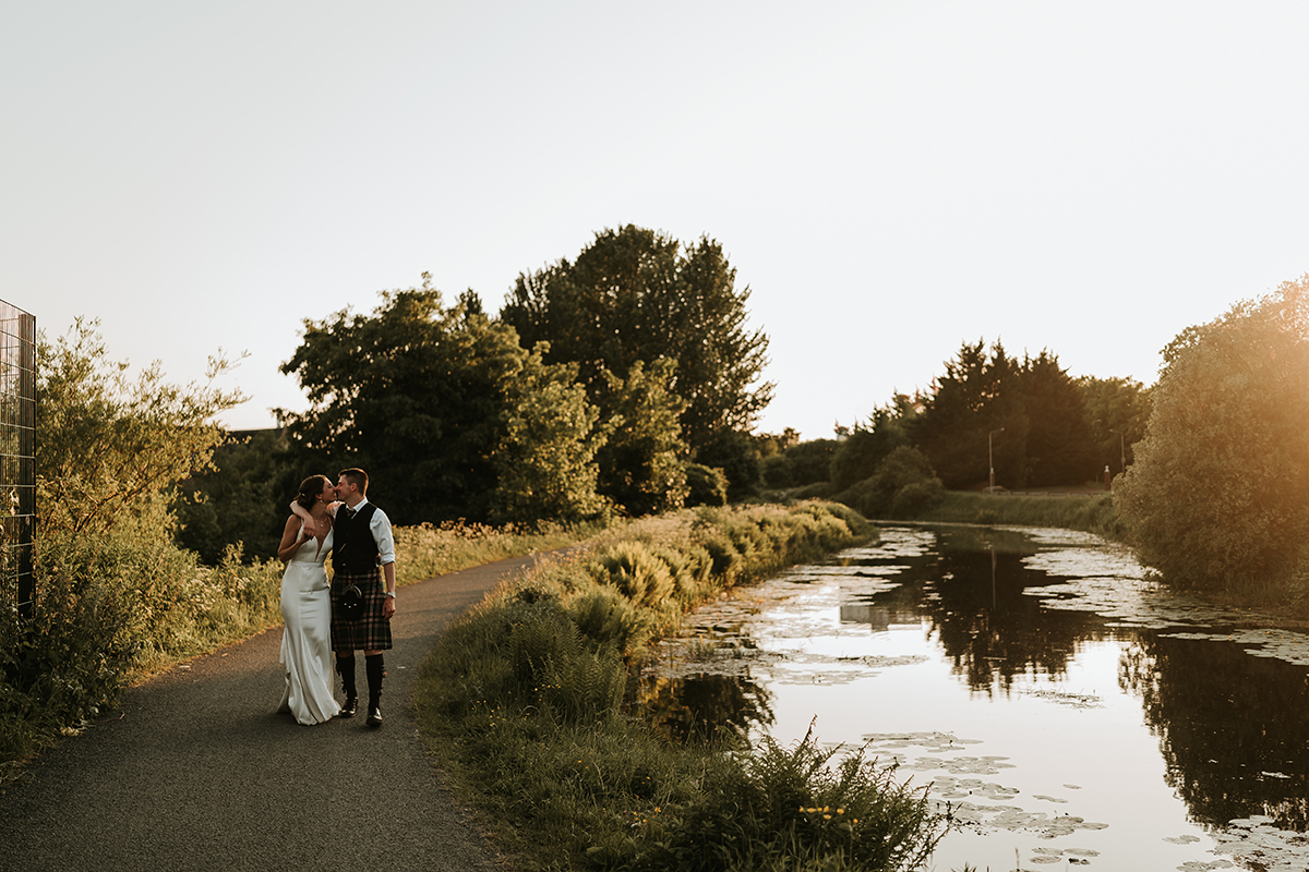 Couple pose beside the Forth and Clyde Canal near The Engine Works wedding venue in Glasgow