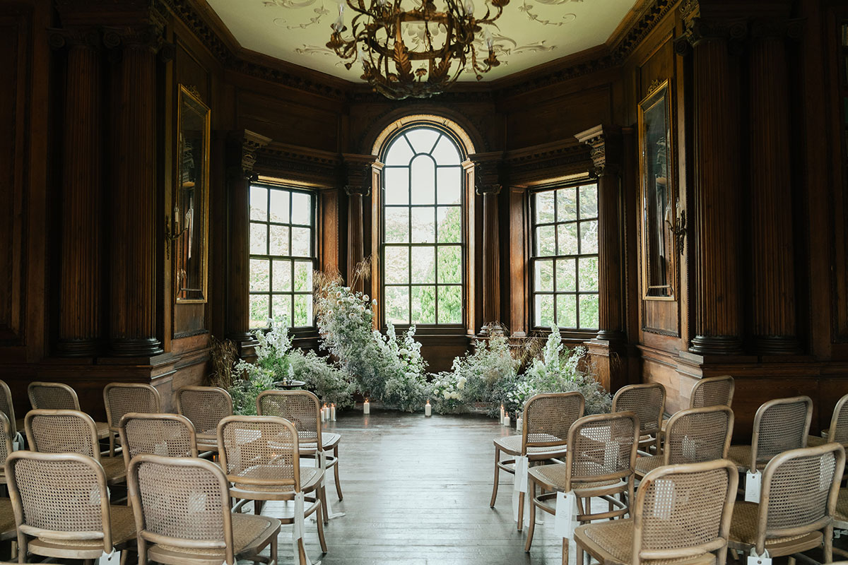 Music Room set for indoor wedding ceremony with floral installations at Gilmerton House East Lothian