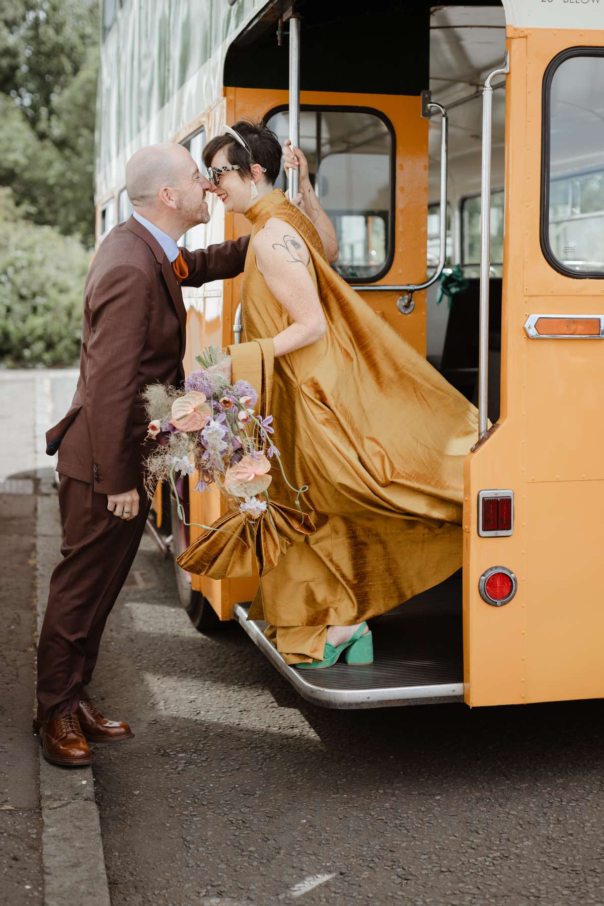 Bride and groom beside a vintage bus on their Glasgow wedding day