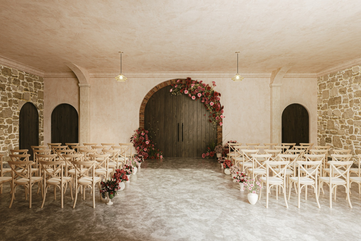 Garden Room at The West Works Glasgow set for a wedding ceremony with wooden chairs, floral aisle arrangements and exposed stone walls