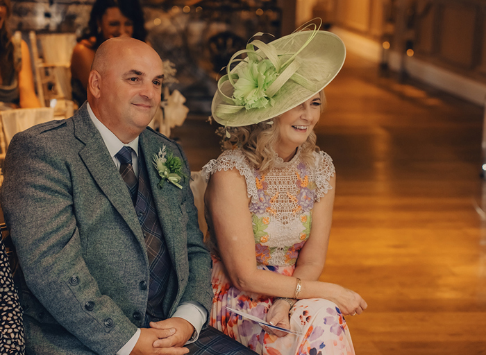 man and woman in formal attire sitting and smiling