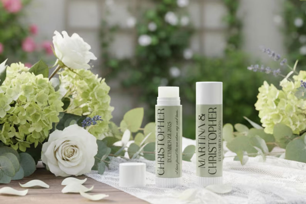 Personalised lip balm wedding favours styled with white roses and green hydrangeas