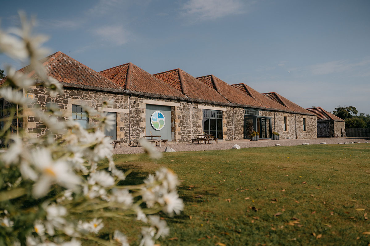 Exterior of Pratis Barns wedding venue in Fife with rustic stone buildings and landscaped grounds.