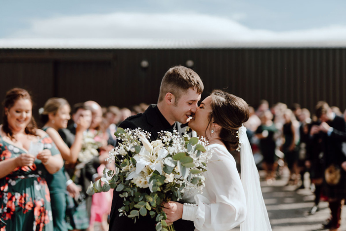 Bride and groom kiss during ceremony at Laxay Barn Lewis