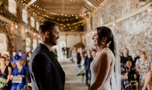 couple at alter inside a barn