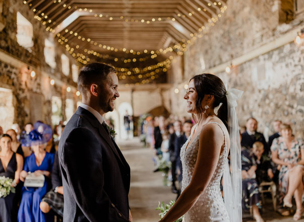 couple at alter inside a barn