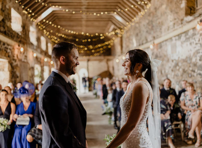 couple at alter inside a barn