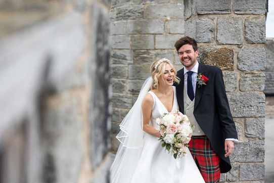 Bride and groom laugh during outdoor couple portraits