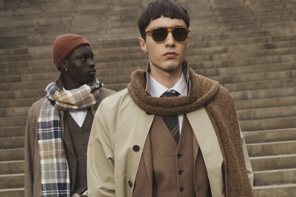Modern groom outfit with checked trousers, waistcoat and trench coat, styled for a Scottish wedding look