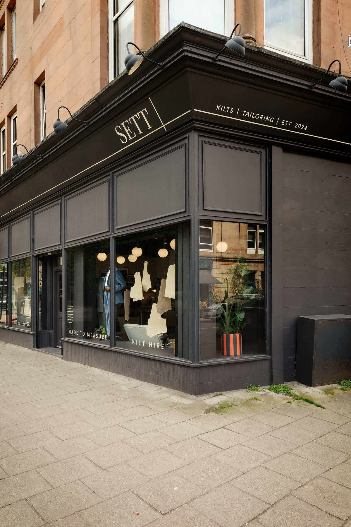 the black painted exterior of a single storey store named 'SETT' that does kilts, tailoring and was established in 2024