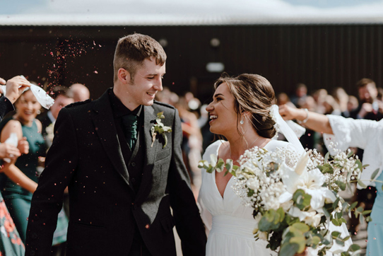 Bride and groom smile during couple portrait