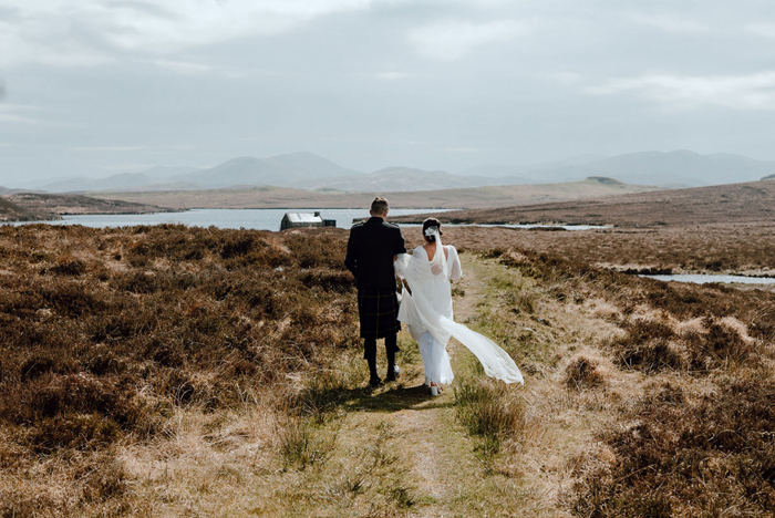 Bride and groom portraits as they walk the landscape
