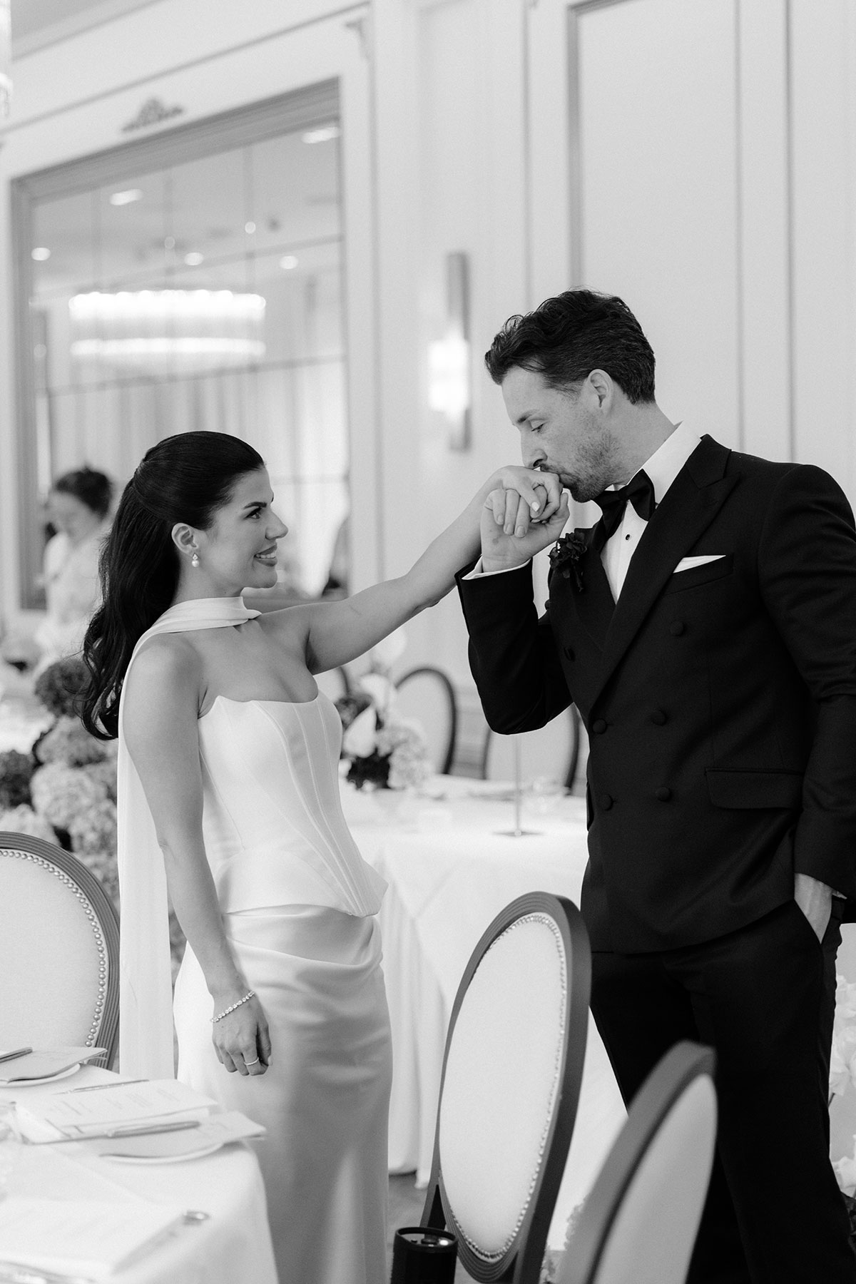 Groom kissing bride’s hand during intimate Glasgow city centre wedding