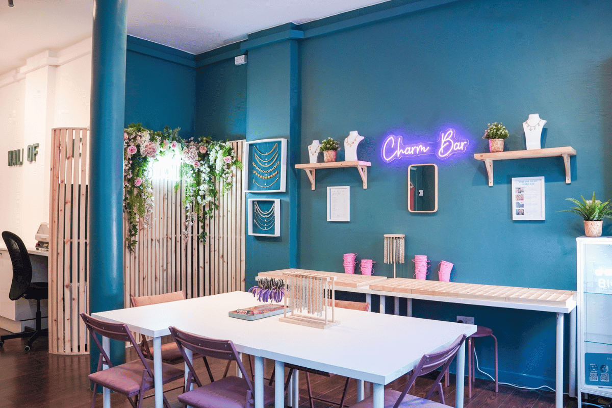 Charm bar jewellery studio with chains, necklace displays and personalised jewellery-making stations for wedding parties.