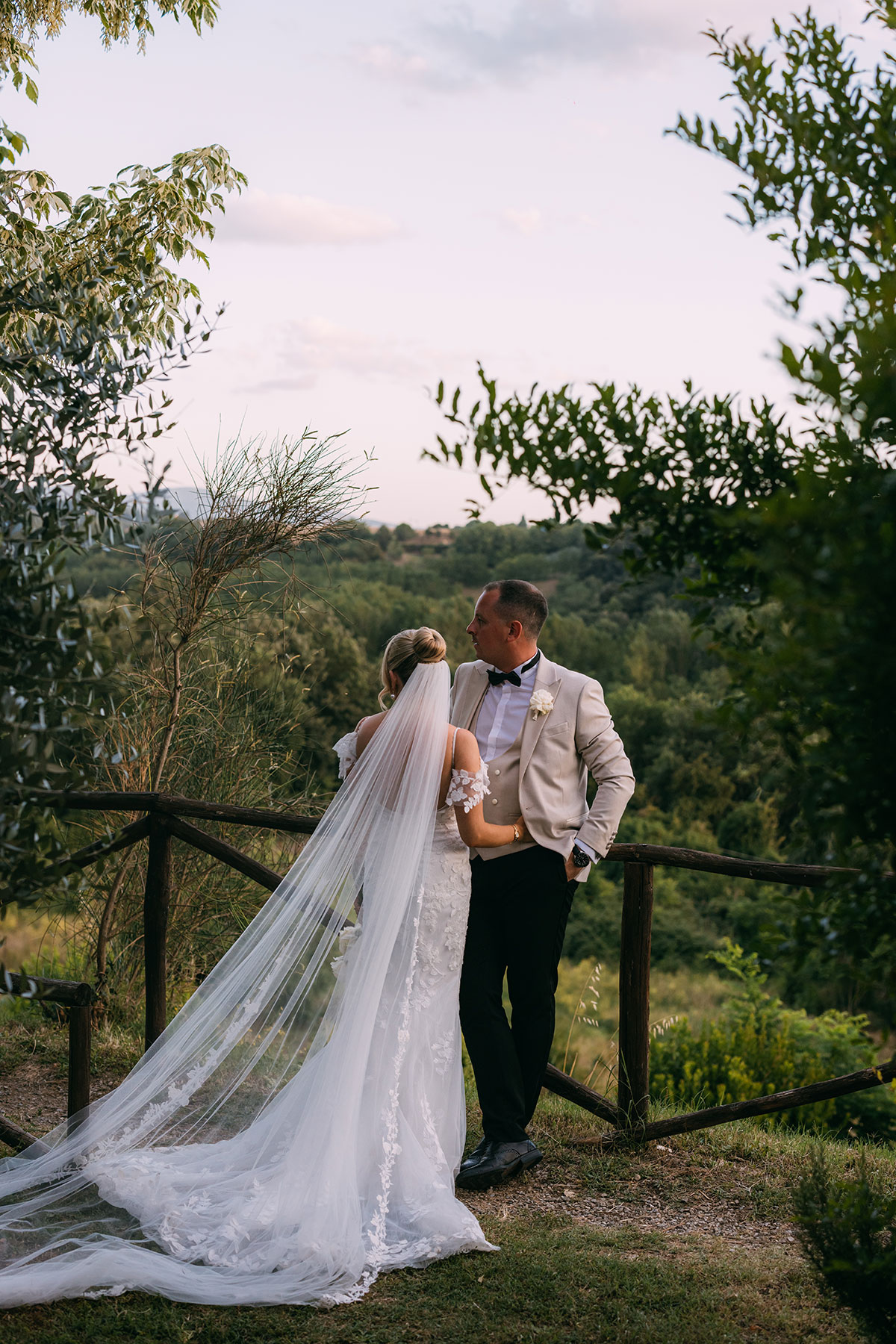 Bride and groom overlooking Tuscan countryside views at Antico Borgo San Lorenzo wedding
