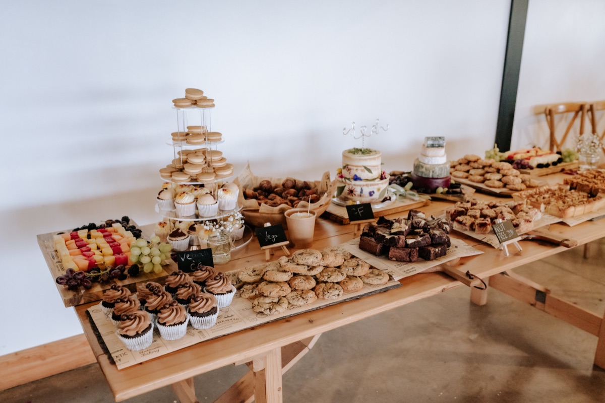 Wedding dessert table at Harvest Moon with cakes, cupcakes, cookies, fruit and sweet treats.
